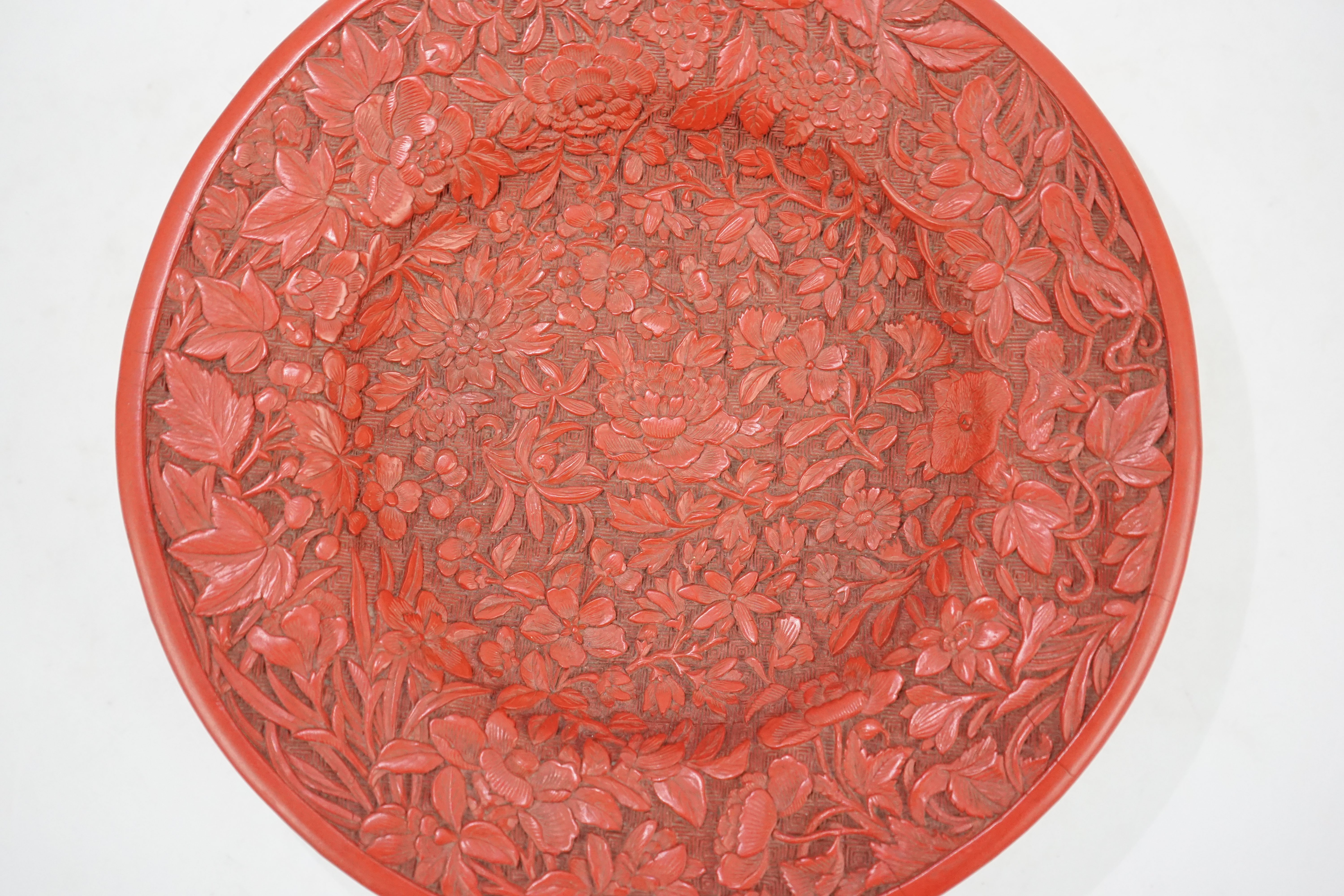 An unusual Chinese cinnabar lacquer ‘thousand flower’ footed dish, 18th/19th century